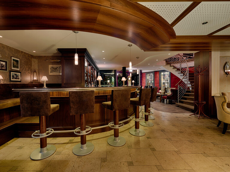 A bar counter with high quality bar stools and comfortable seating.