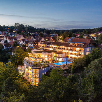 The hotel with an outdoor SPA area in the middle of the green Black Forest landscape.